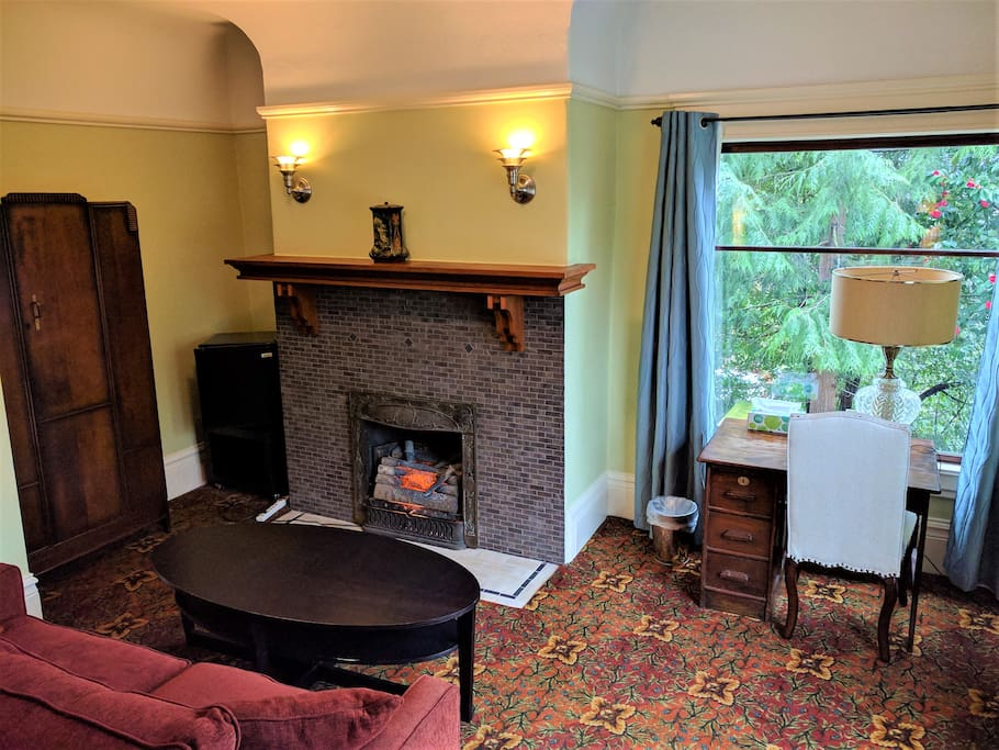Sitting area with loveseat, electric fireplace and desk