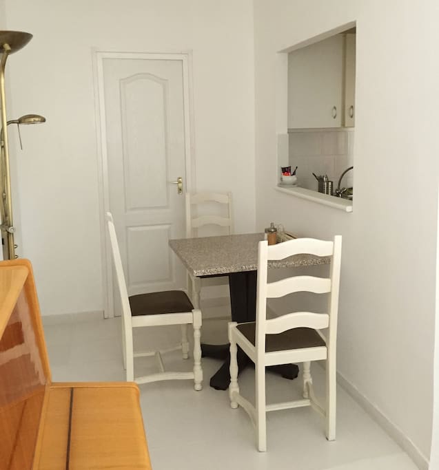 Dining compartment with the kitchen in the background