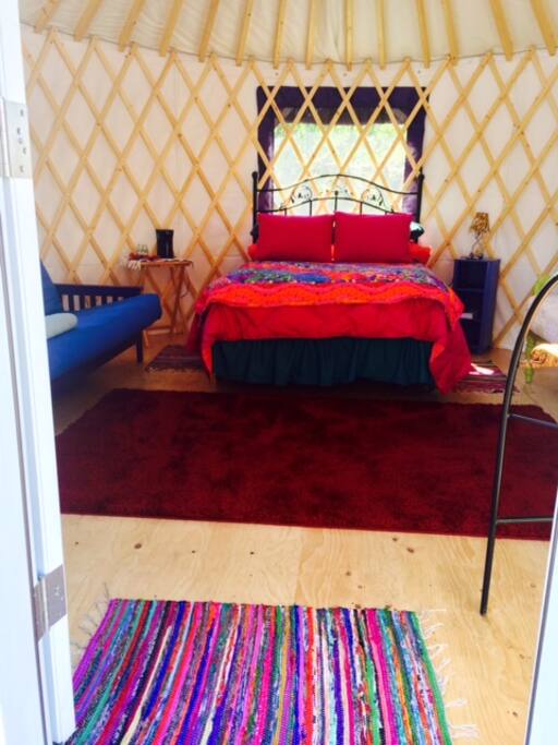 Double bed with handmade quilt and down comforter