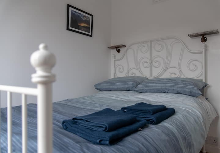 Back bedroom. Double bed with doors to back patio area.  Perfect for eating outside.