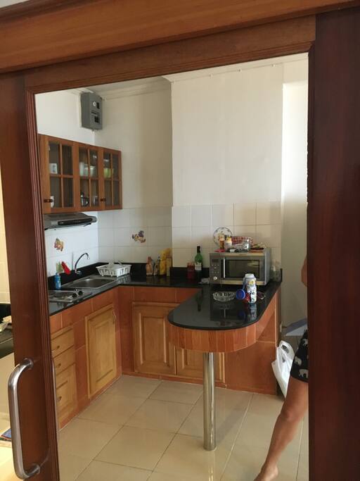 fully stacked kitchen with microwave, toaster, tea maker