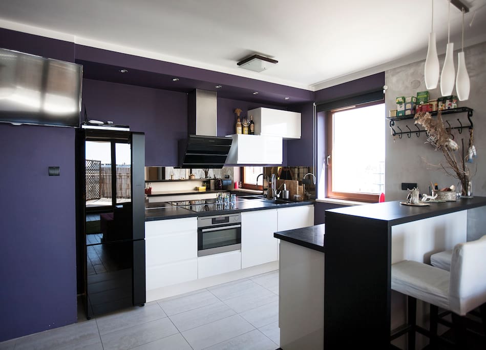 The kitchen is fully equipped and bright. And you will find there washing machine :)