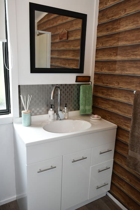 The bathroom is equipped with a large mirror and everything you need for your night away.
