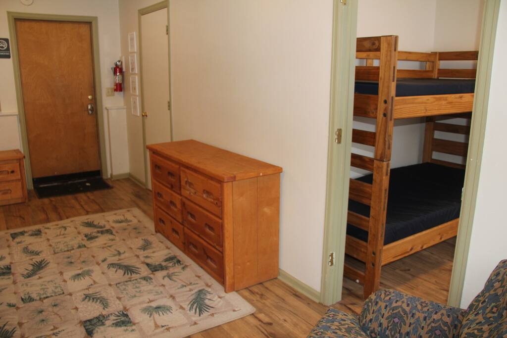 A view from the other side of the room showing the door to the bathroom and the nook