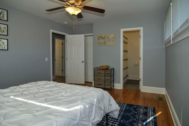 The primary bedroom hosts a queen bed, closet, and attached full bathroom.