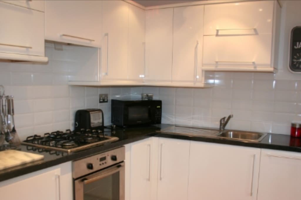 Modern kitchen with dishwasher, microwave , electric oven with gas hob, large fridge freezer and all the essentials needed