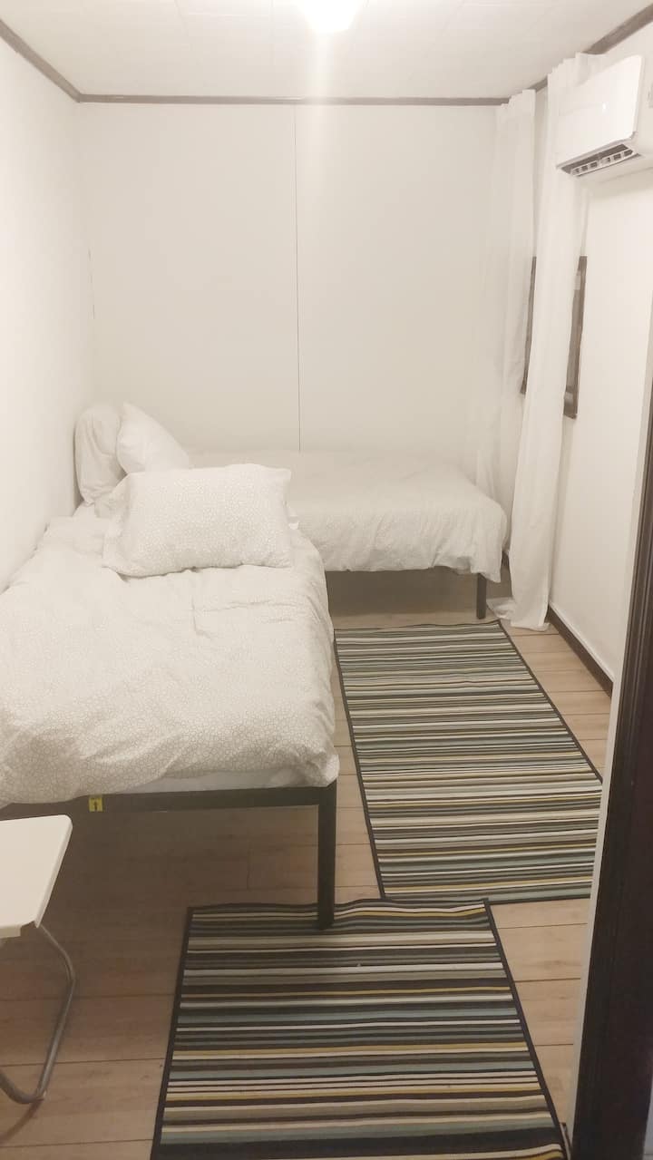 Bedroom 1: 2 single beds, a dresser and unobstructed mountain views from your bed. Wake up to see the gorgeous wilderness! Superior climate control delivers ultimate sleep. 