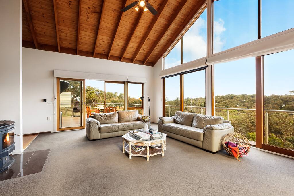 The family room, another angle of the upstairs area. The double sided wood heater provides lovely heat to all this area.