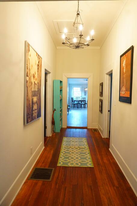 High ceilings with an extended hallway leading to the kitchen.