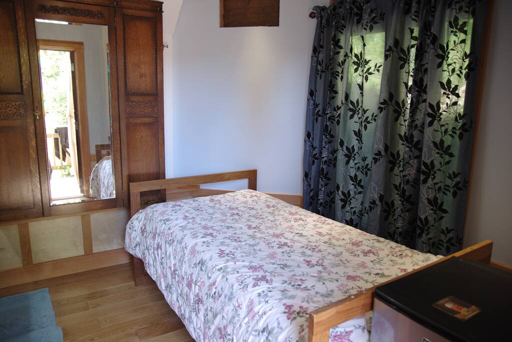 Single Bed with thick topper that doubles as a floor mattress for a second guest.