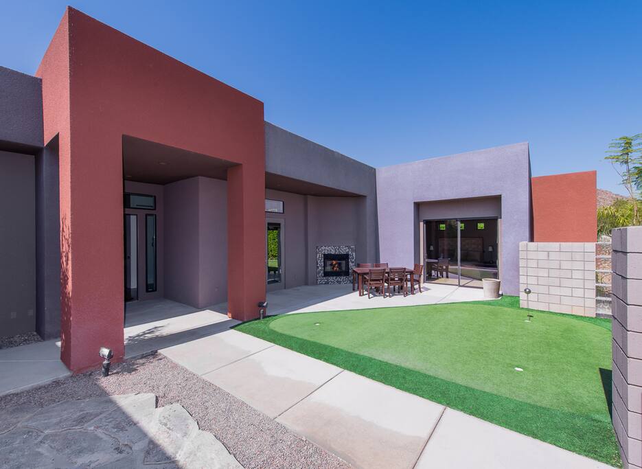 Front courtyard putting green and fireplace with guest house in
background.