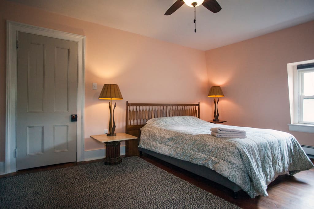 It features a queen size bed with a down comforter.