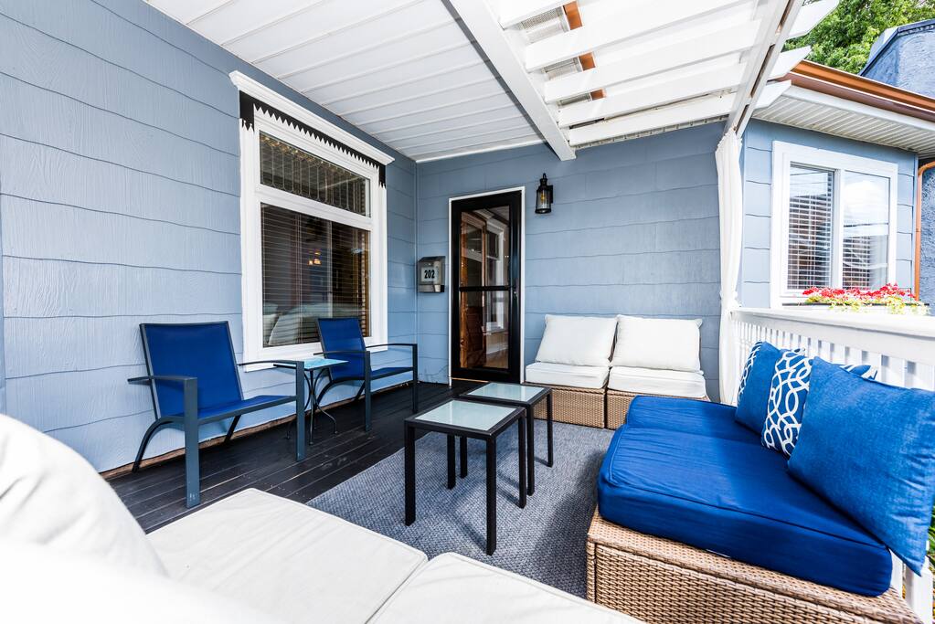 The lounge area on the covered warp-around porch is adjacent to the gourmet kitchen.