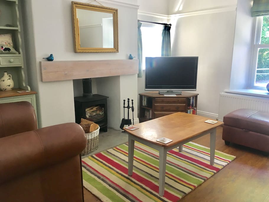 Cosy sitting room with log burner and large TV