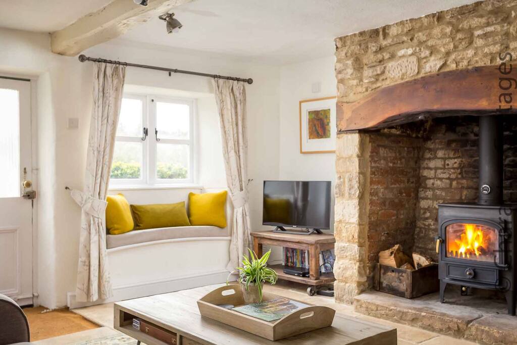The large inglenook fireplace contains a lovely wood burning stove