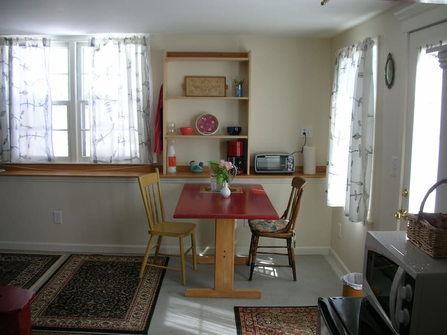 eating area, toaster oven, fridge, microwave