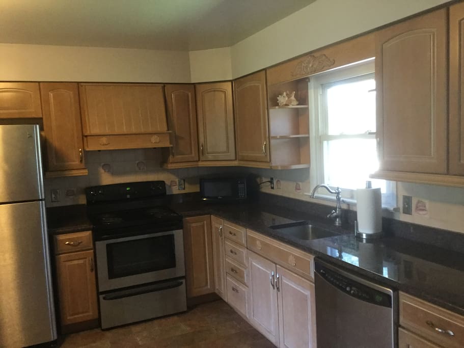 Spacious kitchen with granite counter tops and stainless steel appliances.