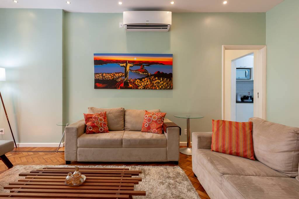 Cozy living room with 3 sofas and air conditioning split