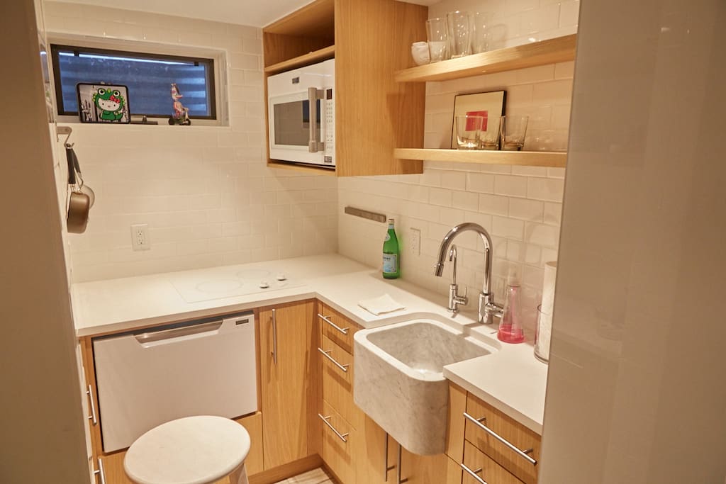 This compact kitchen offers top-of-the-line appliances and an eye-catching modern sink.