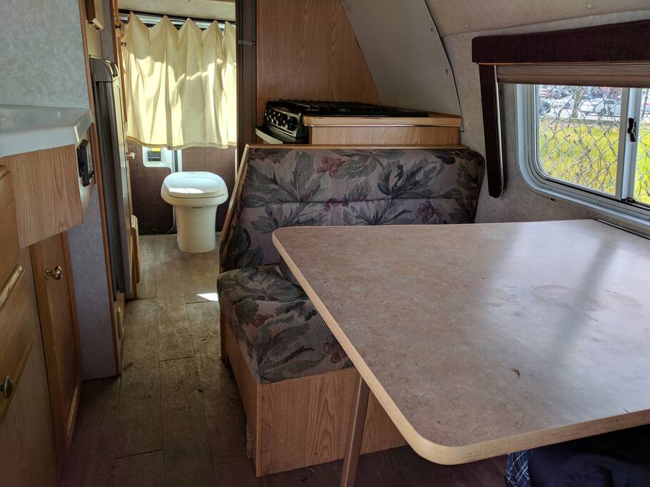 Dining Area with Oven Behind and Toilet.