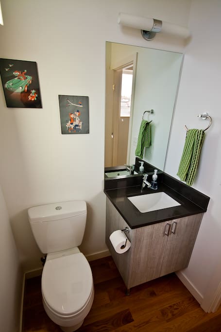 Quarter Bath on the living room / kitchen floor.