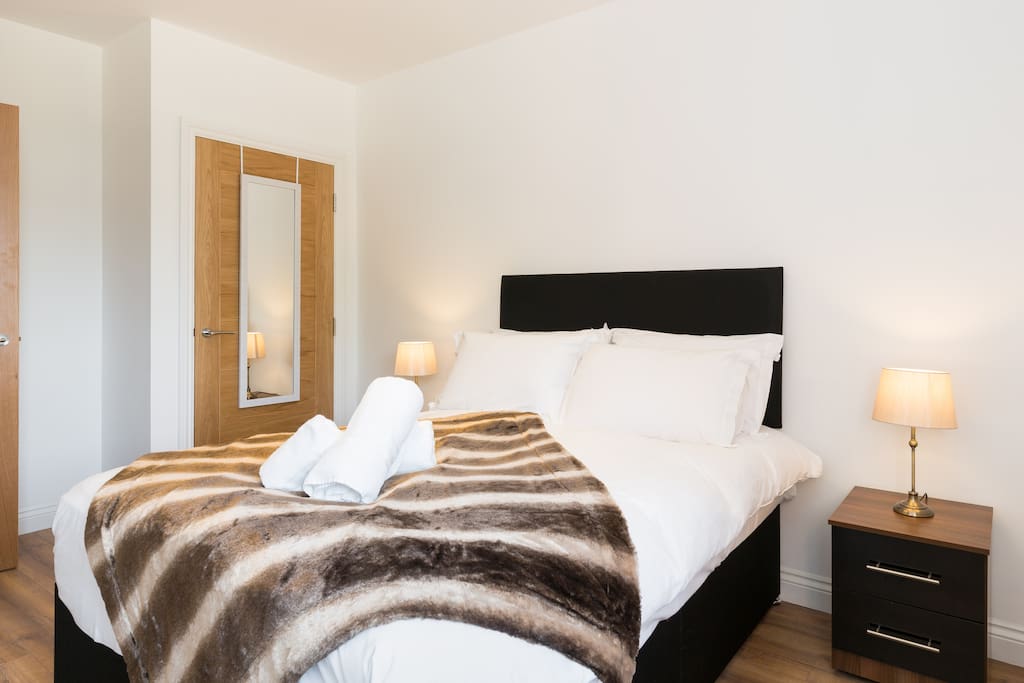 Open and airy bedroom with built in wardrobe
