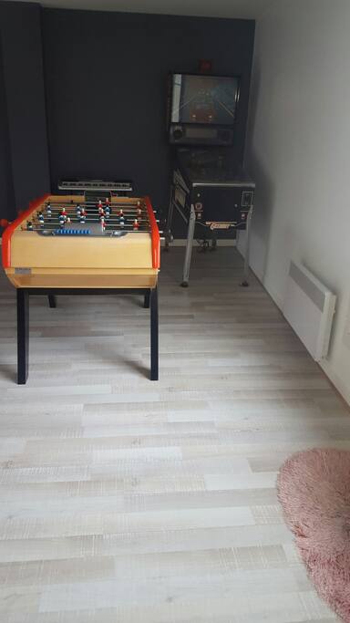 Grande salle avec baby foot et flipper