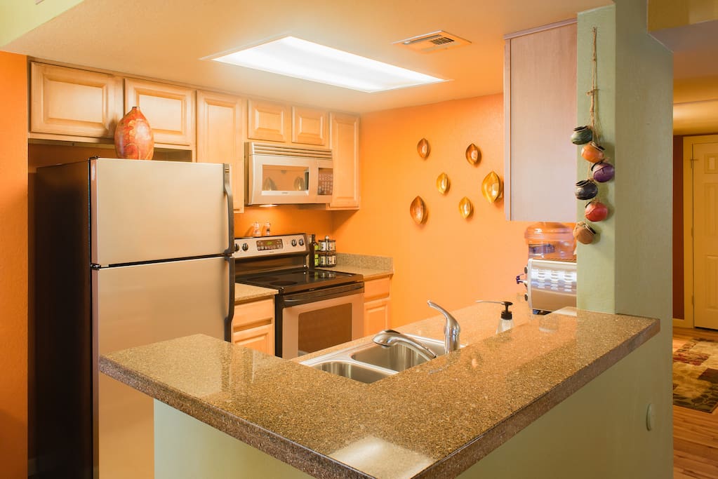 Kitchen features granite counter-tops, and a glass cook-top range.