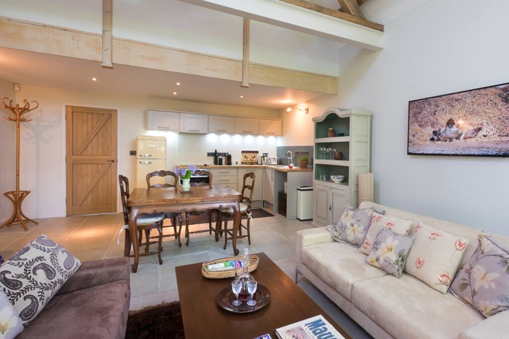 the open plan sitting room with smart wall-mounted tv