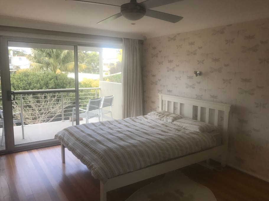 Master bedroom with queen bed and private balcony