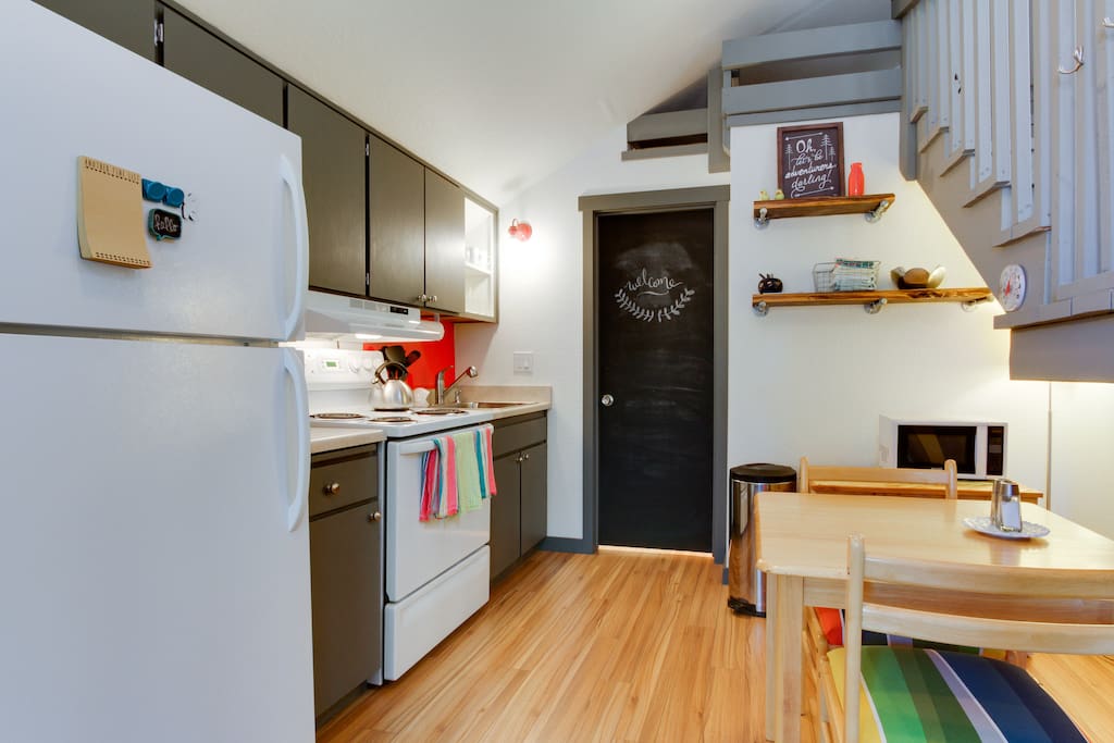 The kitchen has a full-sized refrigerator, stove, and sink. The ohana is stocked with everything you need to make a meal at home. A chalkboard door is ready for your artistic creation!