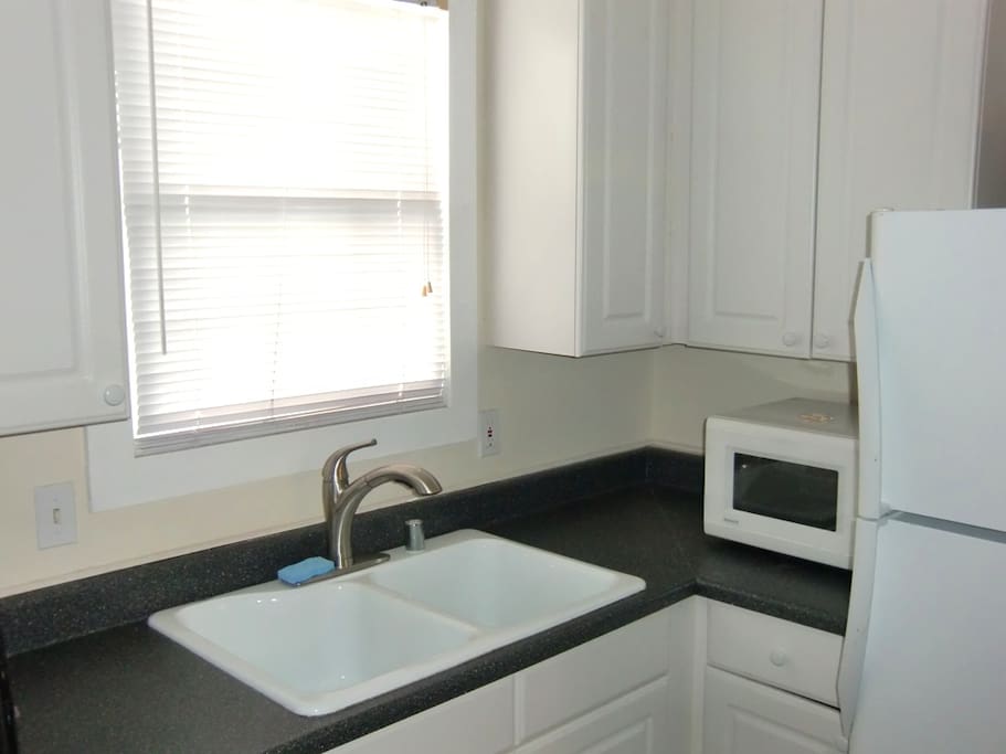 Kitchenette complete with stove, fridge, and dishwasher.