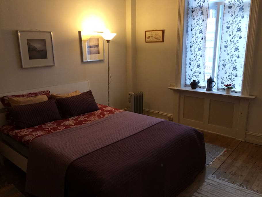 Large bedroom with storage and place for extra mattress, high ceilings.