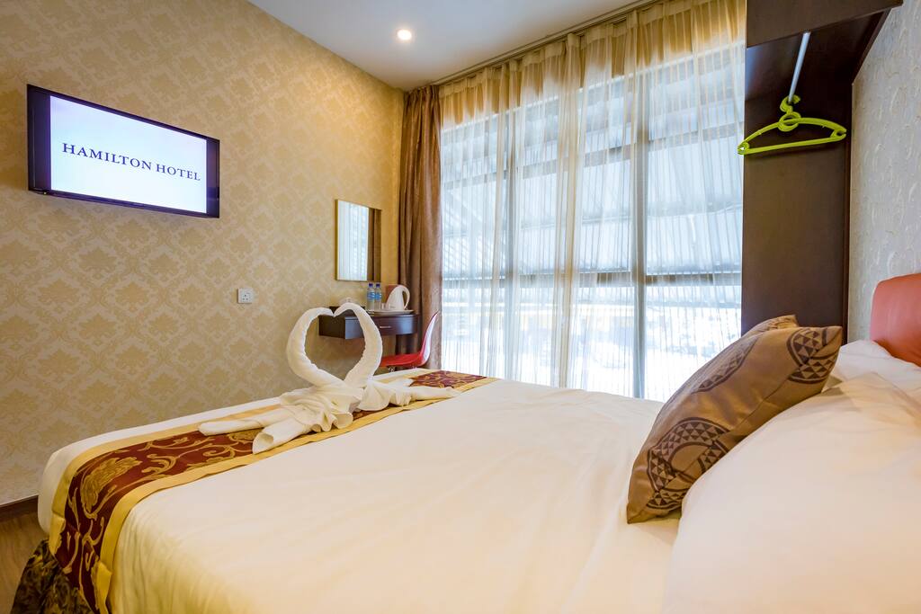 Queen size bed with comfy and clean bed linen and fresh body towels