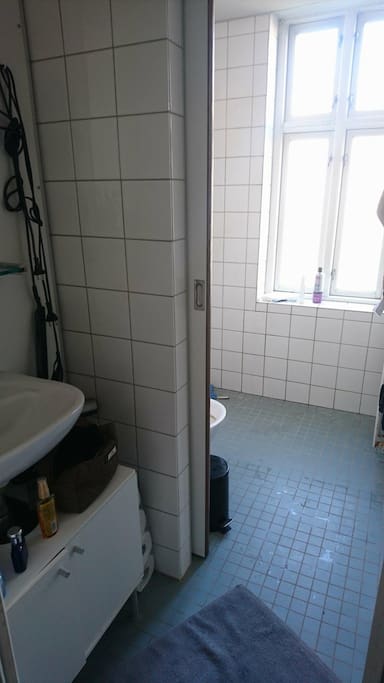 Small and slightly worn bathroom with toilet