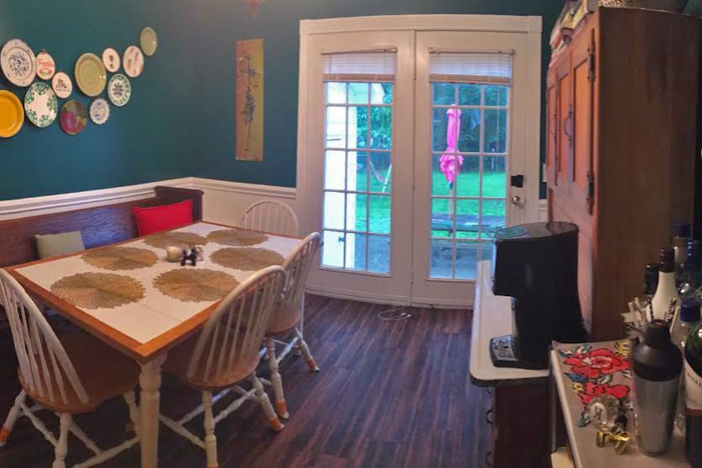 Homey dining room with coffee and tea, looking into backyard.