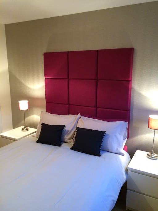 Second bedroom with luxurious headboard, good quality bedding and lovely solid oak flooring
