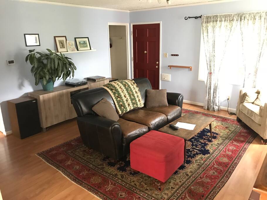 A cozy living room setup for playing games or watching a movie. There is a fireplace across from the couch which is great for the wintertime.