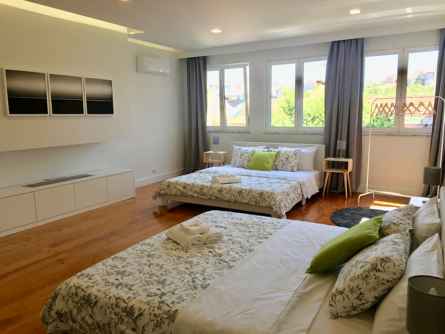 Huge and bright bedroom with kingsize beds and shared bathroom for 4 people.