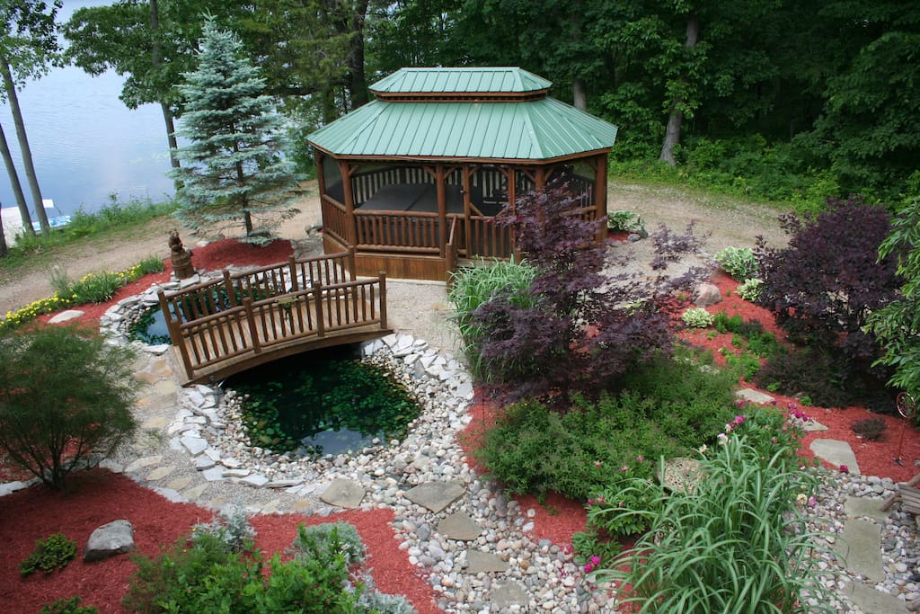 This delightful Amish built log gazebo is set in a perennial garden, complete with Amish log bridge over a little frog pond. The garden gazebo houses your 103 degree hot tub. Go out into it anytime! Comfy spa robes to add to the ambiance.