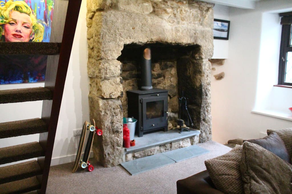 Log burner set in original granite fireplace