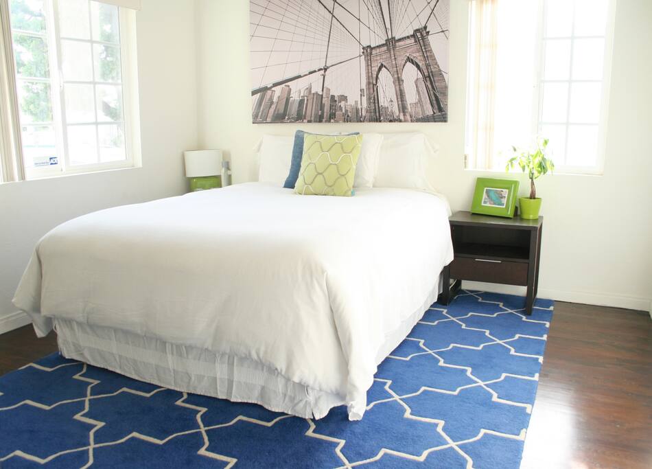 Spacious sunlit bedroom.