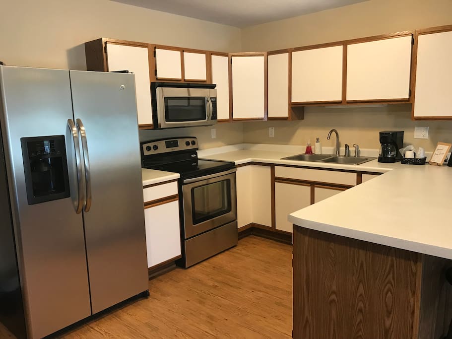 Full kitchen - Fridge, microwave, oven/stove, and coffee maker.