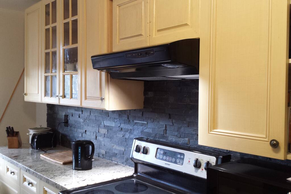 Kitchen is fully equipped with dishes, pots, pans & cutlery.