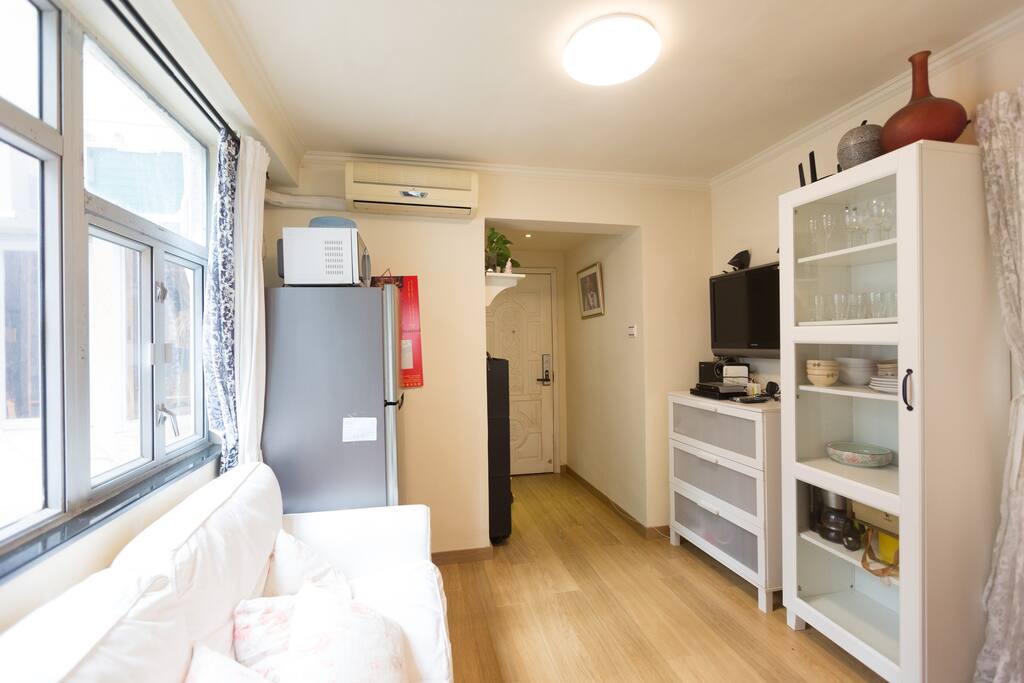 Living Room with fridge, TV and cabinet to store things