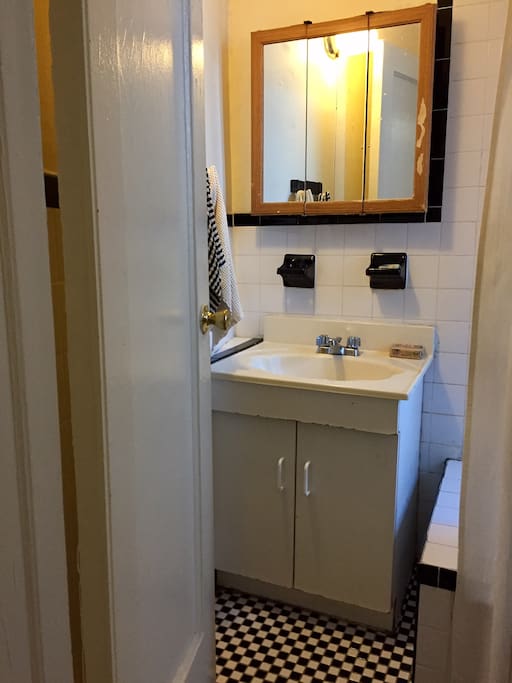 The bathroom is very quaint with original black and white tiles.