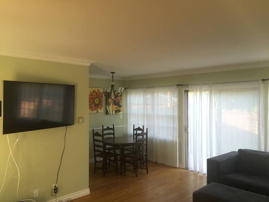 big screen smart tv with netflix and dinning room