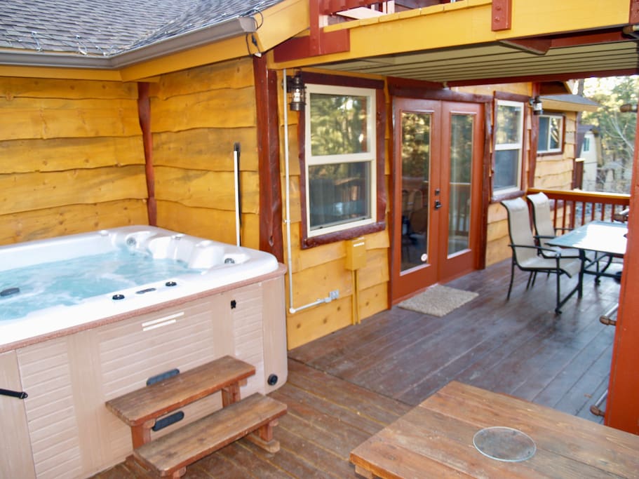 The deck has a 5 person spa, a natural gas grill, and seating for 10.
