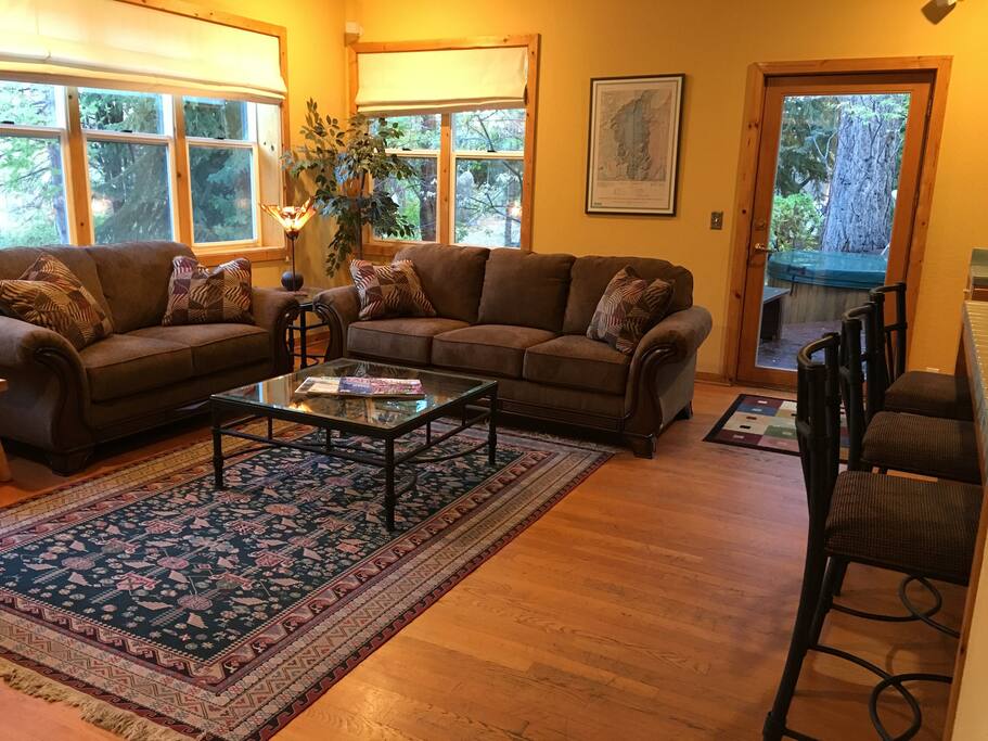 The TV and Family room, adjacent to the kitchen (on the right) and access to the back deck with hot tub through the french door.