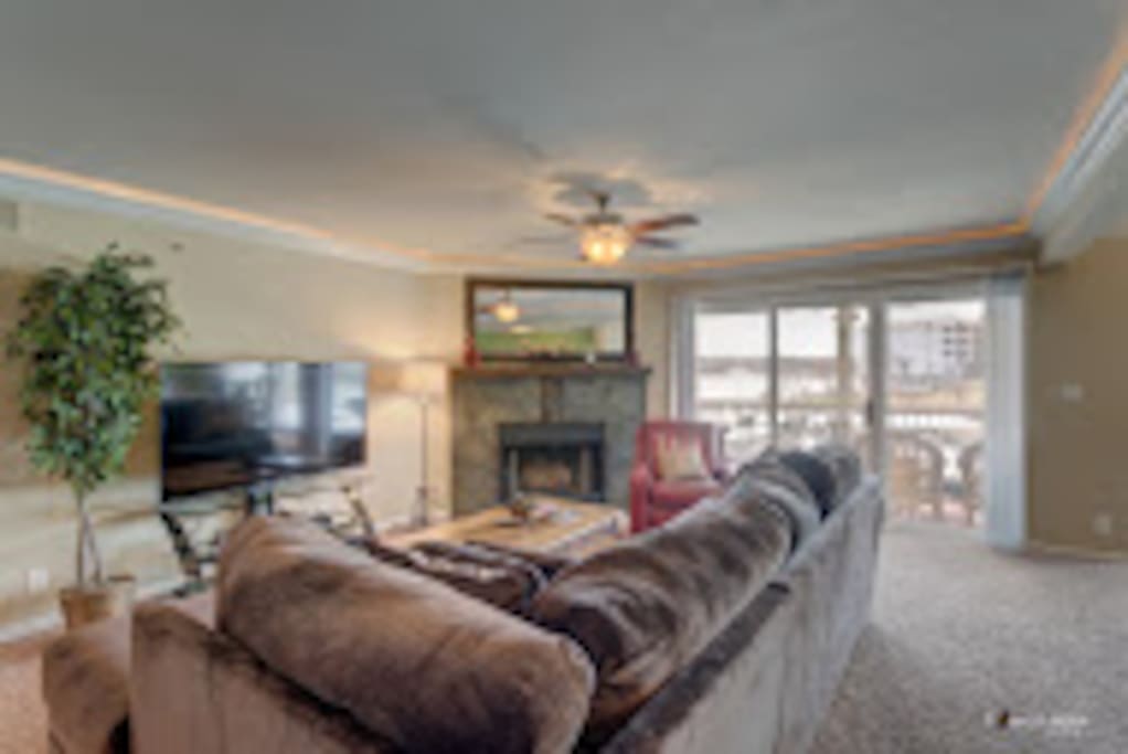 Family room with fireplace, 60" Smart TV, large sectional can sleep 2.